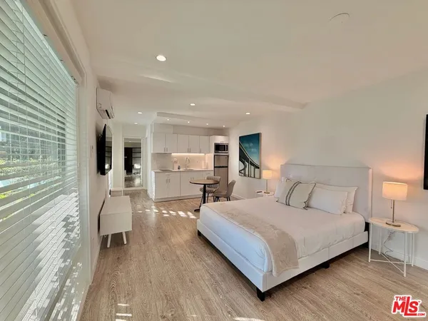 a bedroom with a bed and glass door