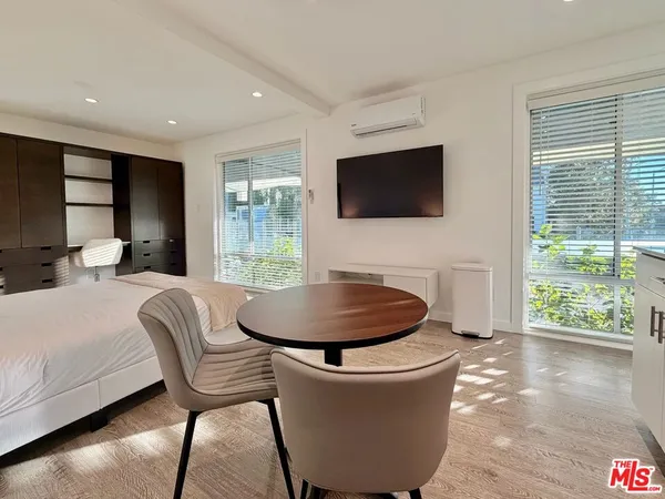 a living room with a large window and a flat screen tv