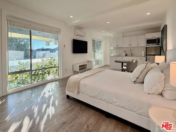 a bedroom with a large bed and a large window
