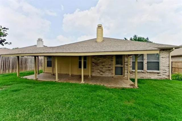 a view of a house with a yard and sitting area
