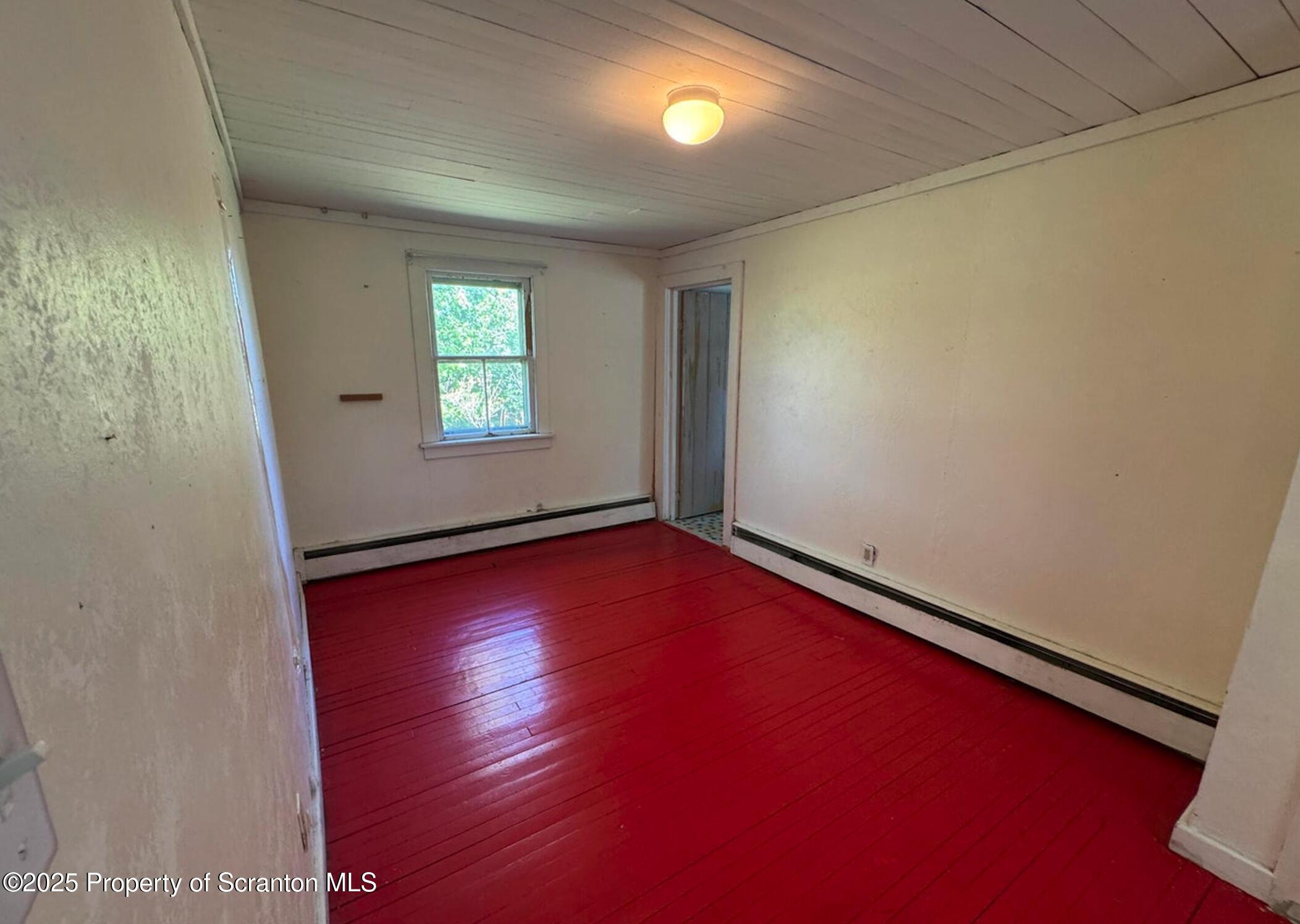 394 Dennis Road Honesdale, PA 18431 - Photo 7 of 13 an empty room with wooden floor and windows