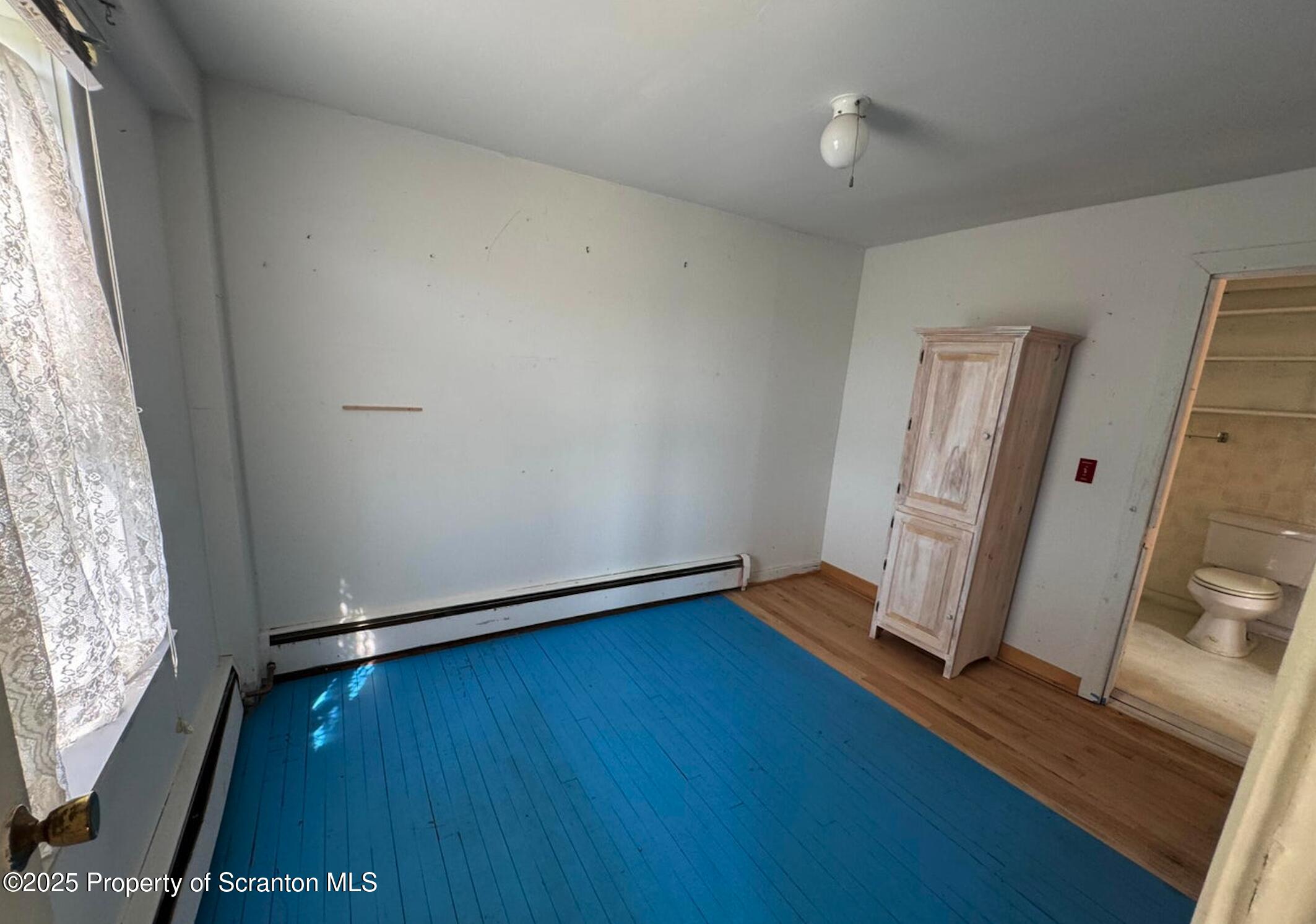 394 Dennis Road Honesdale, PA 18431 - Photo 9 of 13 an empty room with wooden floor and windows