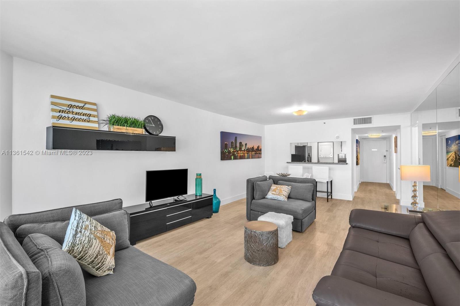 Omni Miami, FL 33132 - Photo 12 of 22 a living room with furniture and a flat screen tv