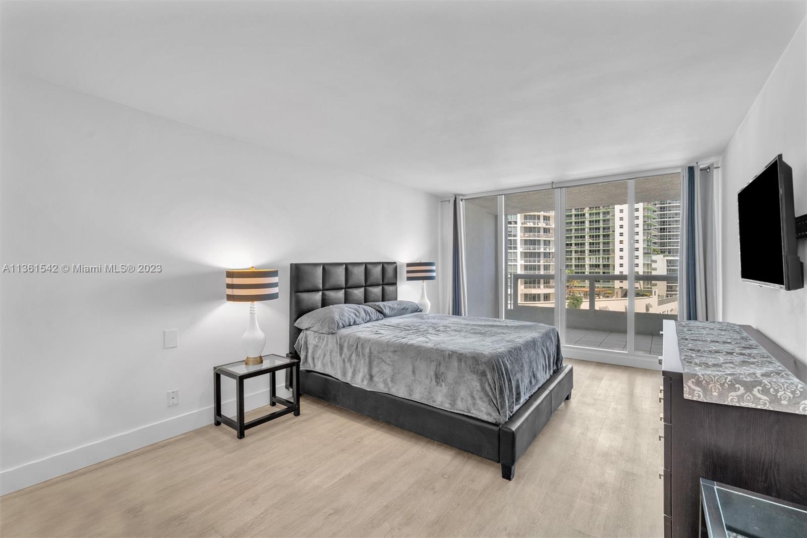 Omni Miami, FL 33132 - Photo 16 of 22 a spacious bedroom with a bed and a flat screen tv