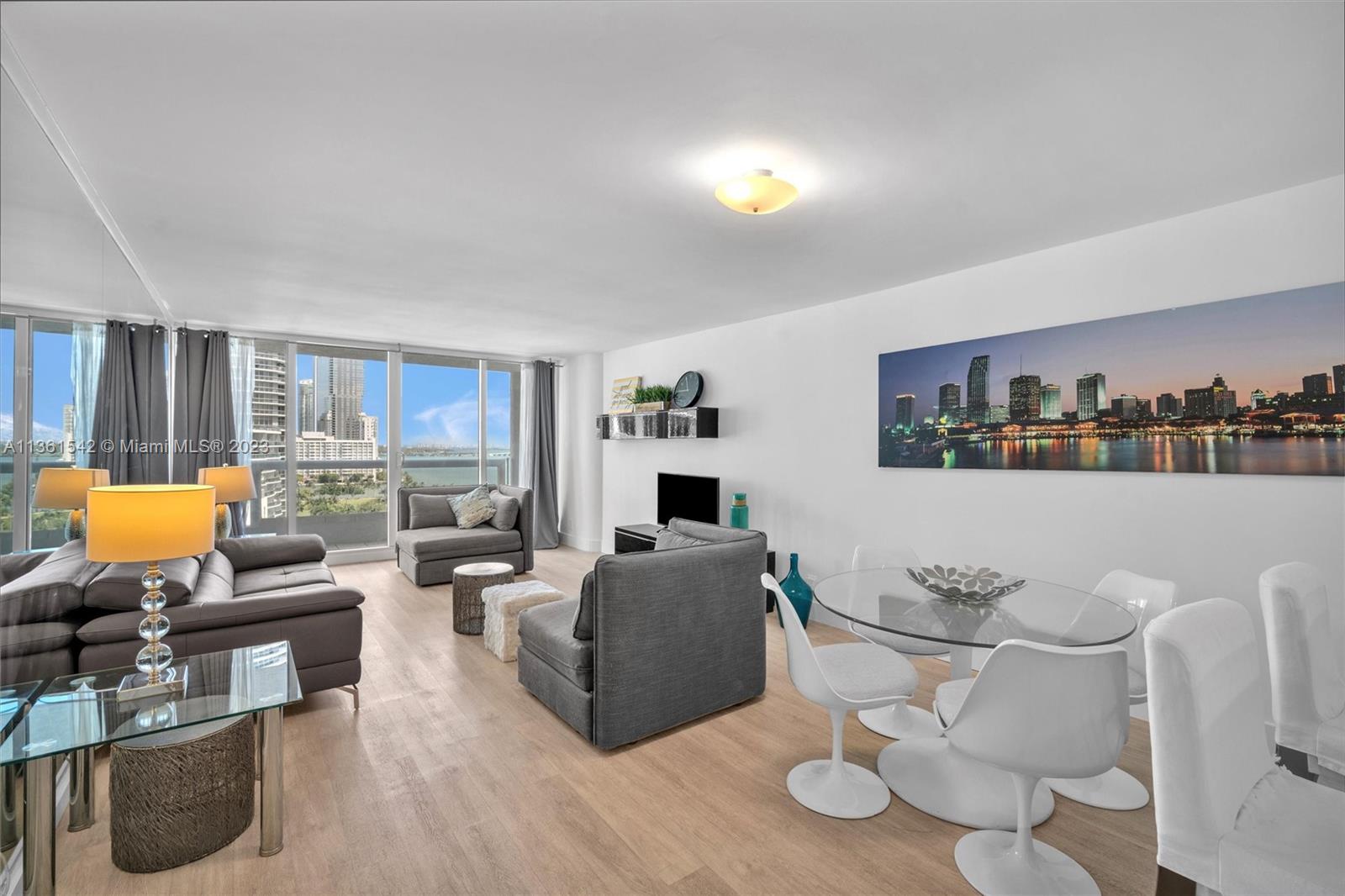 Omni Miami, FL 33132 - Photo 8 of 22 a living room with furniture and a wooden floor