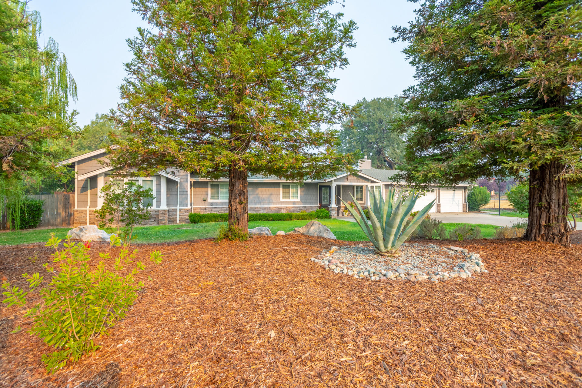 a brick house with trees in front of it