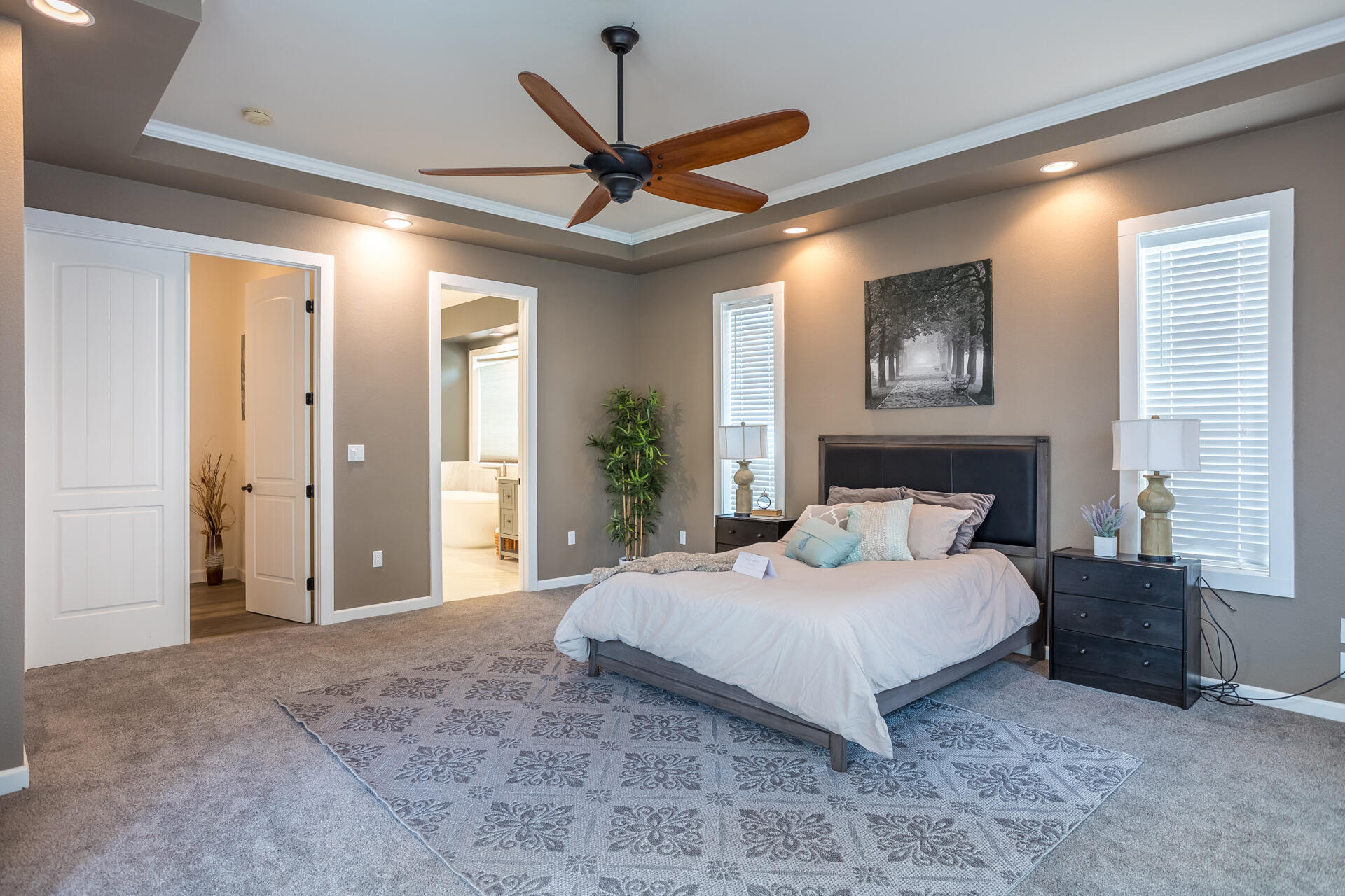1102 Hope Lane Redding, CA 96003 - Photo 11 of 29 a bedroom with a large bed and a ceiling fan