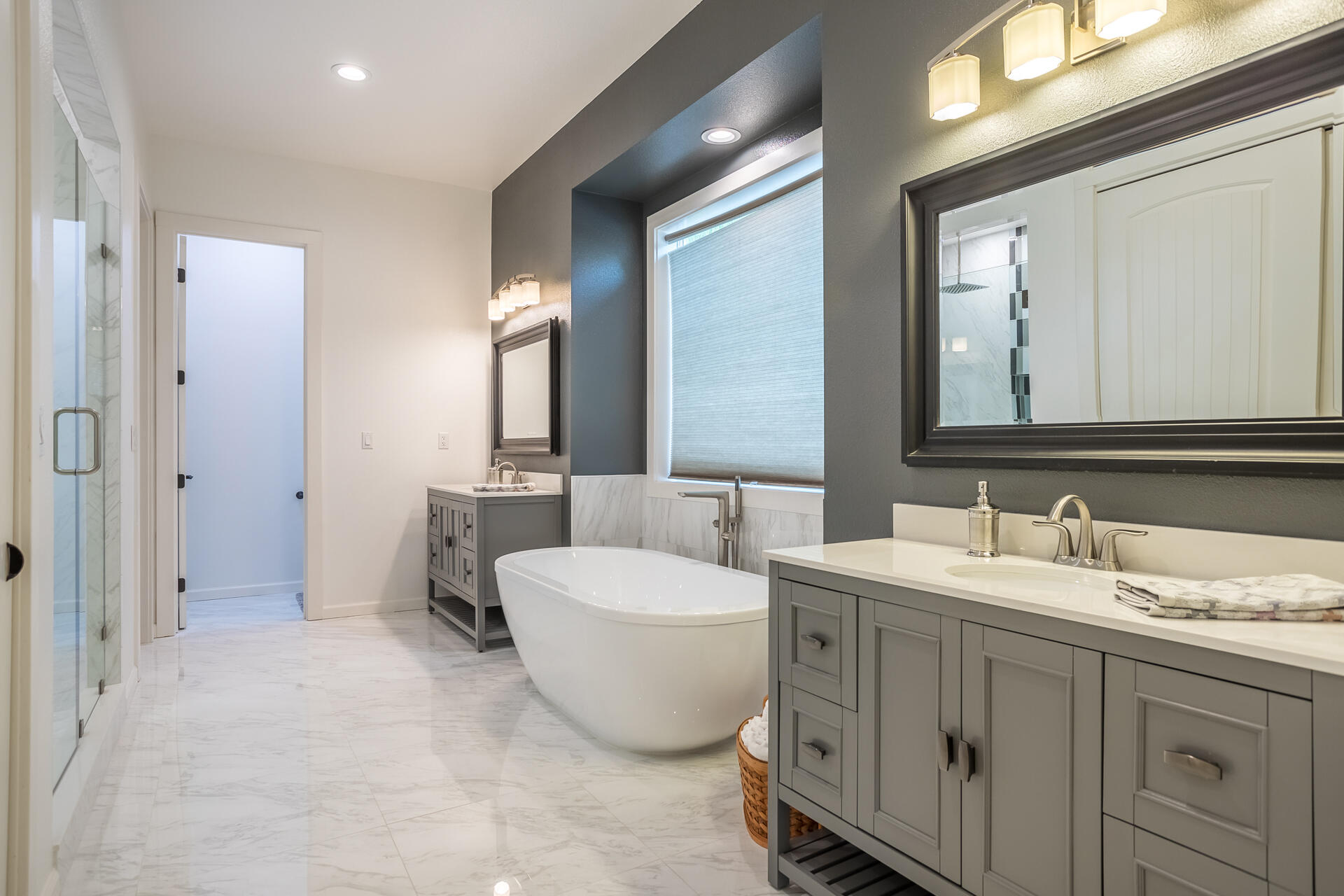 1102 Hope Lane Redding, CA 96003 - Photo 16 of 29 a spacious bathroom with a double vanity sink double mirror and bathtub