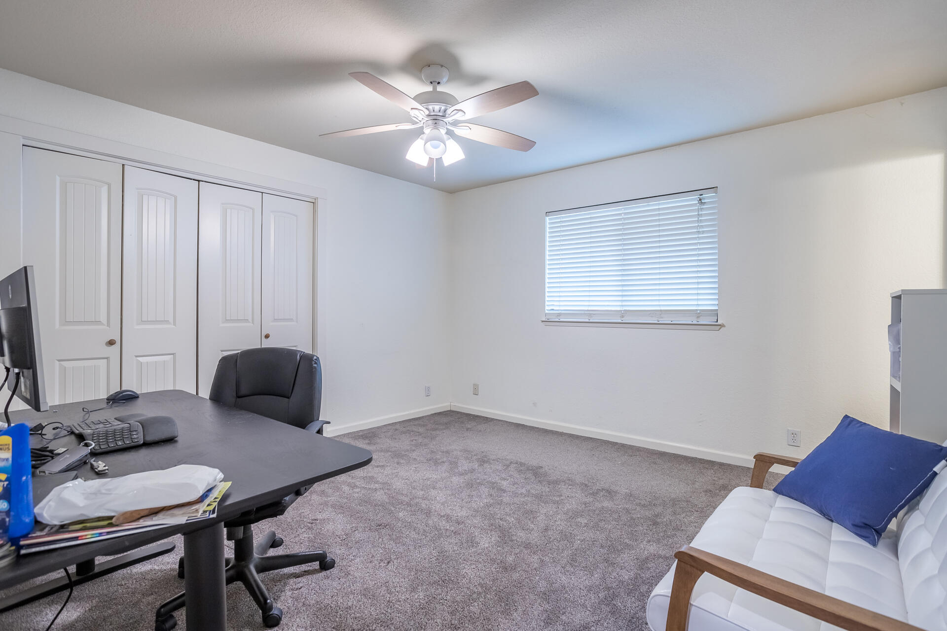 1102 Hope Lane Redding, CA 96003 - Photo 19 of 29 a bedroom with furniture and a chandelier fan
