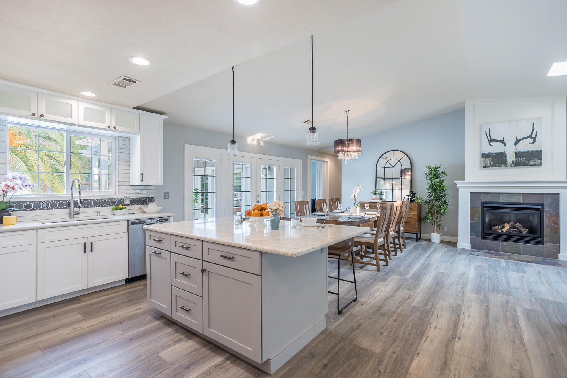1102 Hope Lane Redding, CA 96003 - Photo 7 of 29 a open kitchen with kitchen island a large island a sink stainless steel appliances and windows