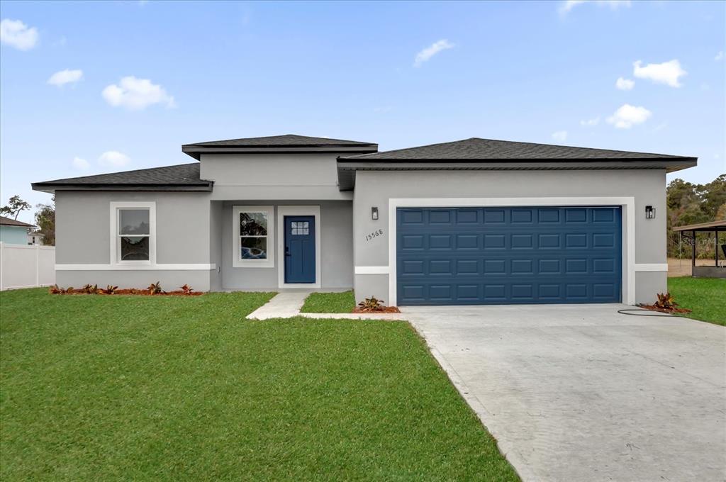 15568 Southwest 46th Circle Ocala, FL 34473 - Photo 1 of 1 a front view of a house with a yard and garage