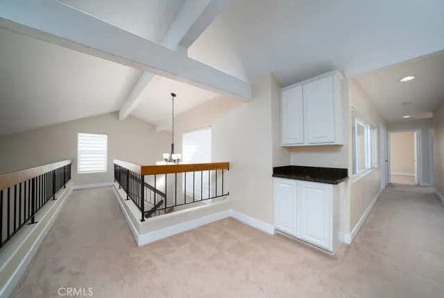 a large white kitchen with a large window and stainless steel appliances
