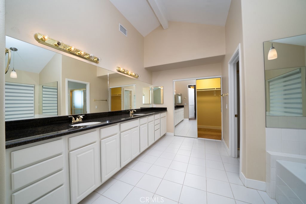 34 Columbus Irvine, CA 92620 - Photo 19 of 33 a large white kitchen with a large window and stainless steel appliances