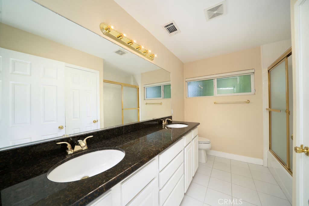 34 Columbus Irvine, CA 92620 - Photo 20 of 33 a bathroom with a granite countertop sink and a mirror