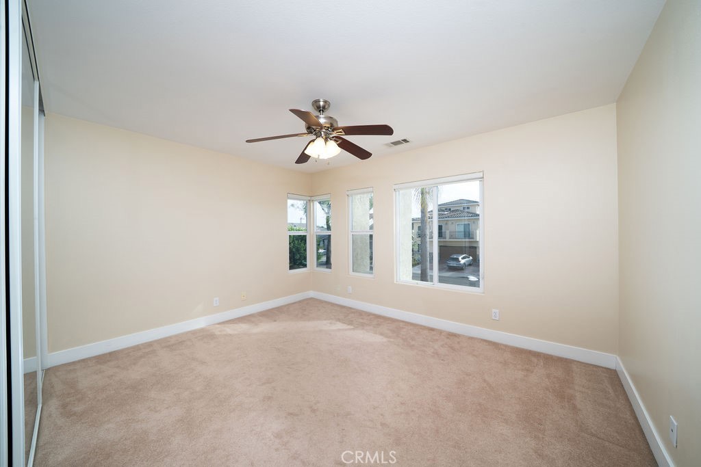 34 Columbus Irvine, CA 92620 - Photo 25 of 33 an empty room with ceiling fan and windows