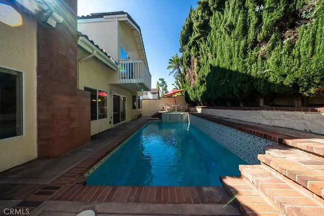 swimming pool view with a garden space