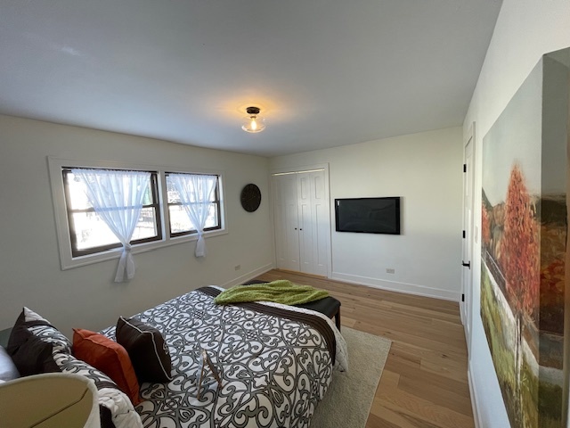 446 East 90th Street Chicago, IL 60619 - Photo 19 of 33 a bedroom with a bed and a flat screen tv