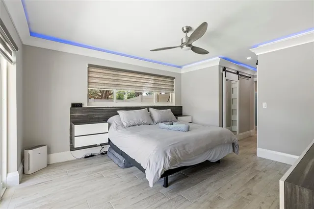 a bedroom with a large bed and a large window