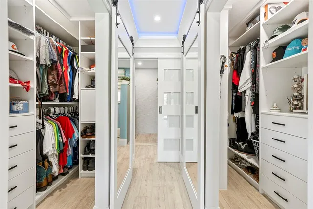 a view of a room with wooden floor and windows