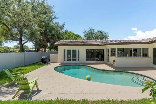 a view of a house with backyard sitting area and garden
