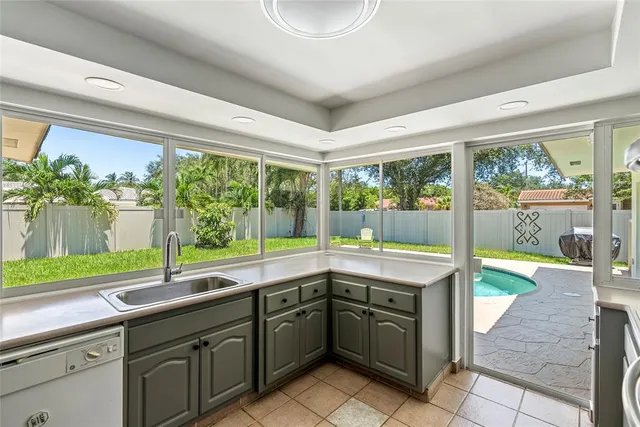 a kitchen with a sink and a large window