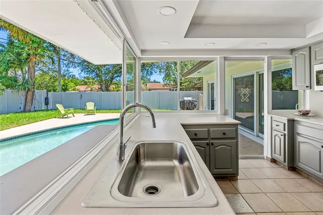 a kitchen with a sink and a stove top oven