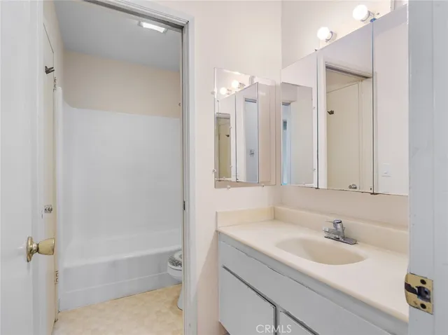 a bathroom with a bath tub with a shower