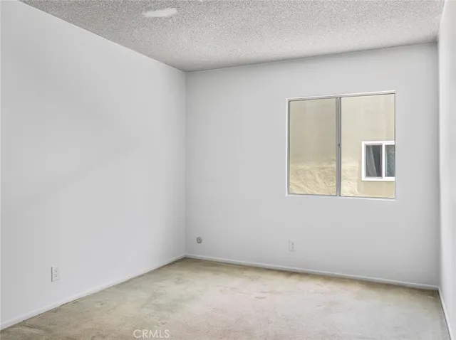 a view of a kitchen with wooden cabinet and a refrigerator