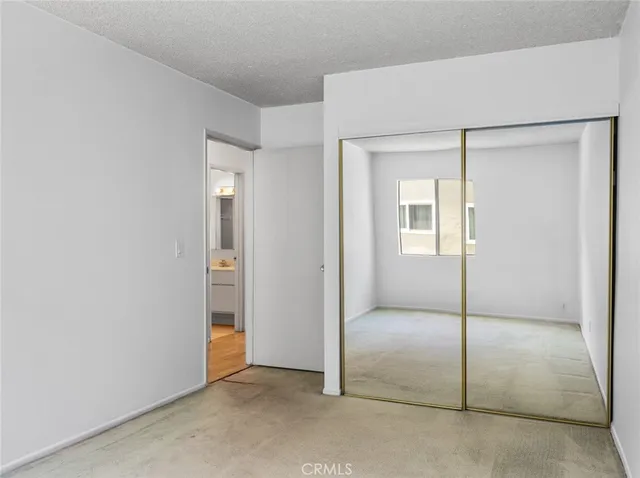 a view of a refrigerator in kitchen and a window