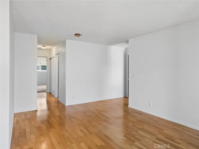 a kitchen with kitchen island granite countertop cabinets and wooden floor