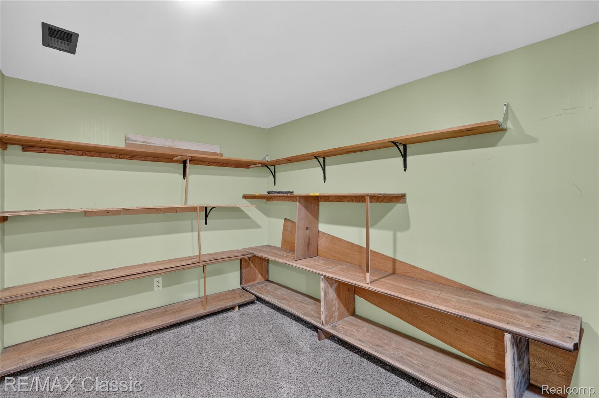 12189 Gage Road Holly, MI 48442 - Photo 47 of 69 Room featuring extensive built-in wood shelving for storage