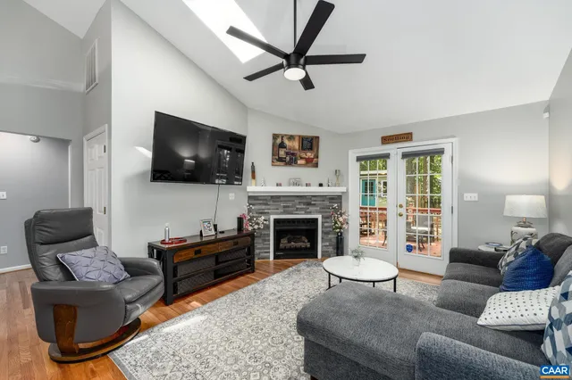 a living room with furniture a fireplace and a flat screen tv