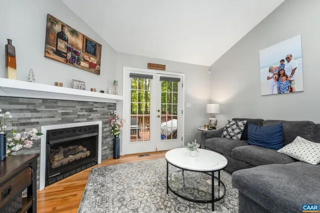 a living room with furniture a window and a fireplace