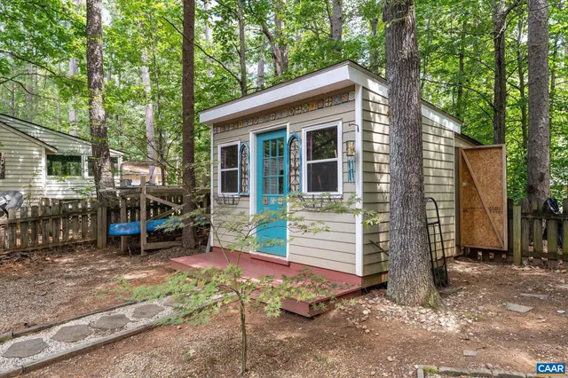 a view of a house with backyard porch and sitting area