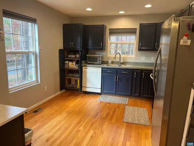 a kitchen with stainless steel appliances granite countertop a refrigerator and a sink