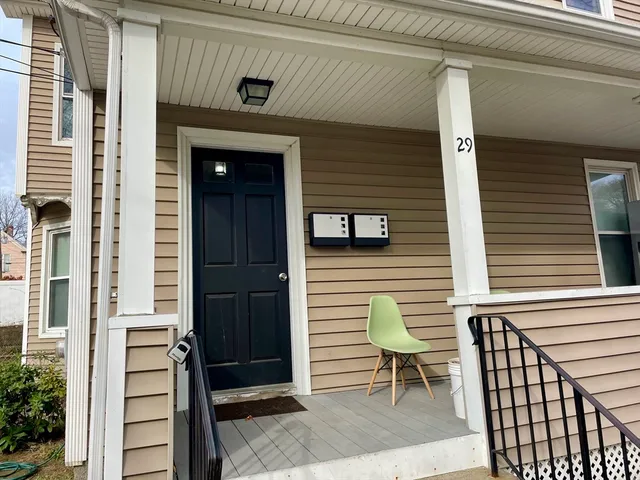 a front view of a house with a chairs