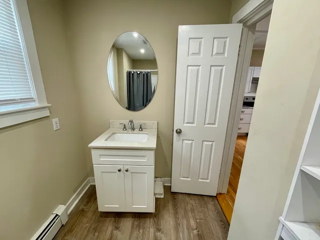 a bathroom with a sink a mirror and a shower