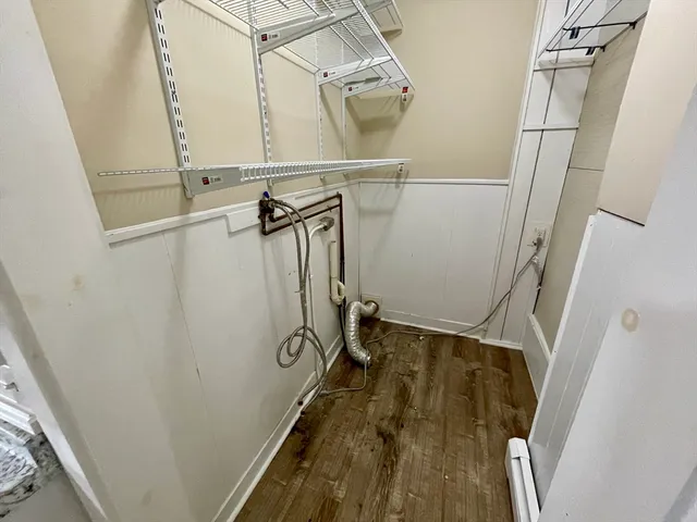 a view of walk in closet with wooden floor