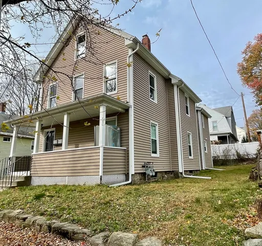 a view of a house with a yard