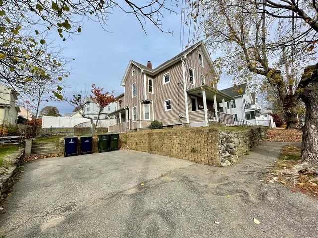 a view of a white house covered with snow in front of house