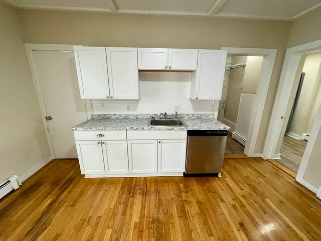 a kitchen with a sink window and cabinets
