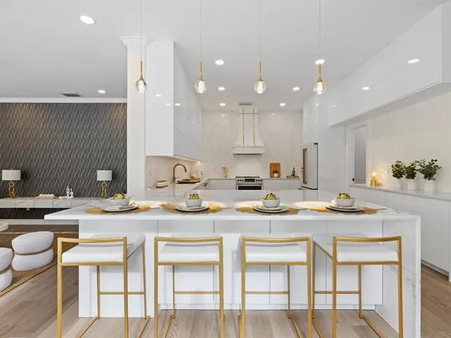 a kitchen with a stove and chairs