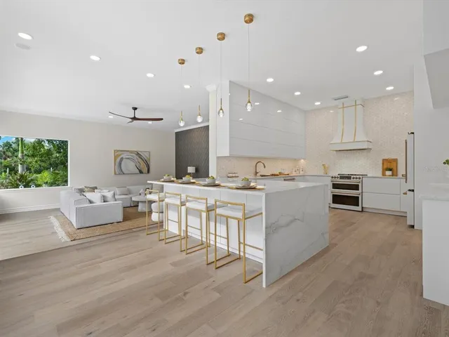 a large kitchen with kitchen island a sink a stove a center island and a stove