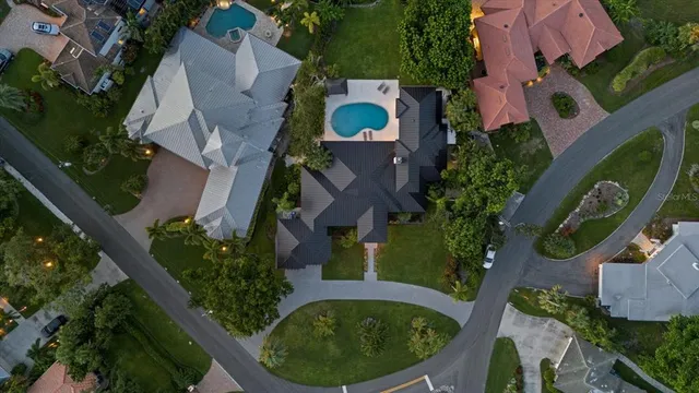 an aerial view of residential house with outdoor space and swimming pool
