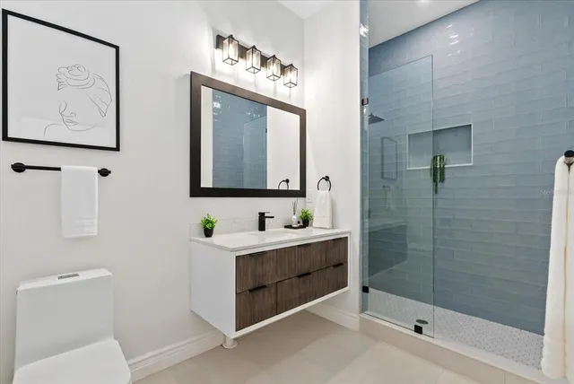 a bathroom with a toilet sink and mirror