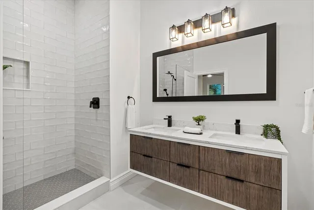 a bathroom with a sink vanity and mirror