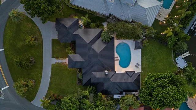 an aerial view of a house with garden space and trees