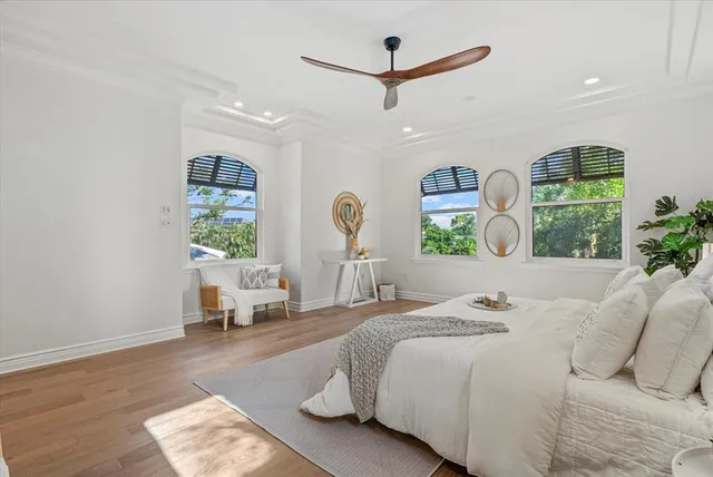 a bedroom with a bed mirror and window