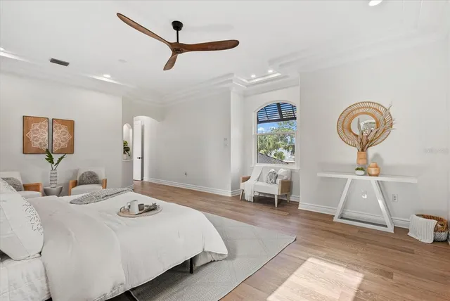 a bedroom with a bed and a mirror on the dresser