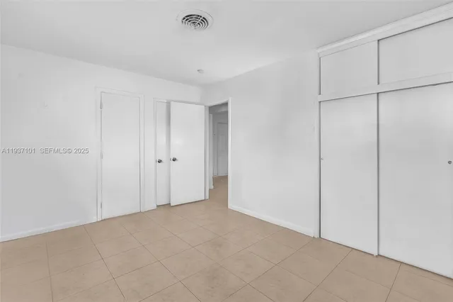 a bathroom with a toilet sink vanity and shower